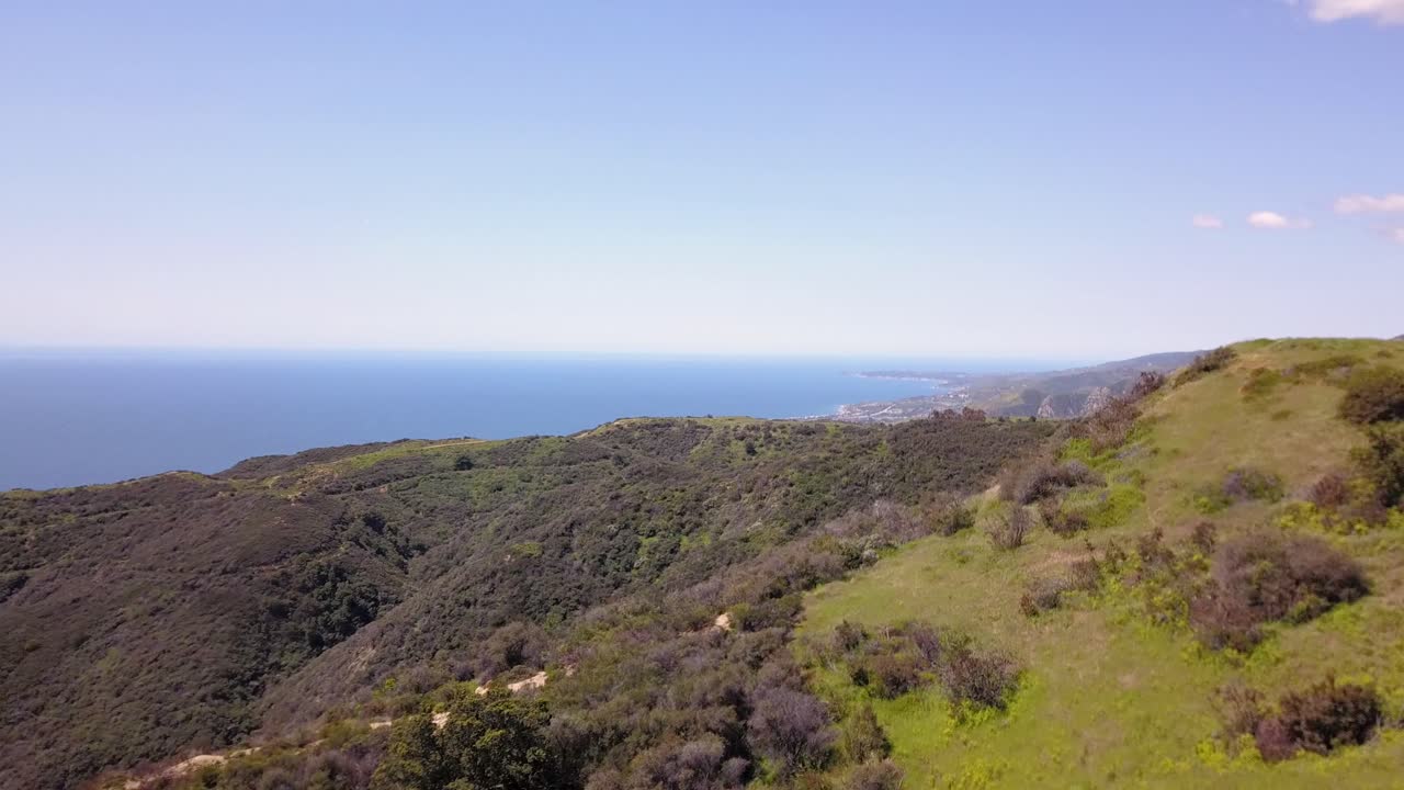 4K Aerial drone shot of the Pacific Ocean with Skyline of Malibu, Los Angeles California in the background