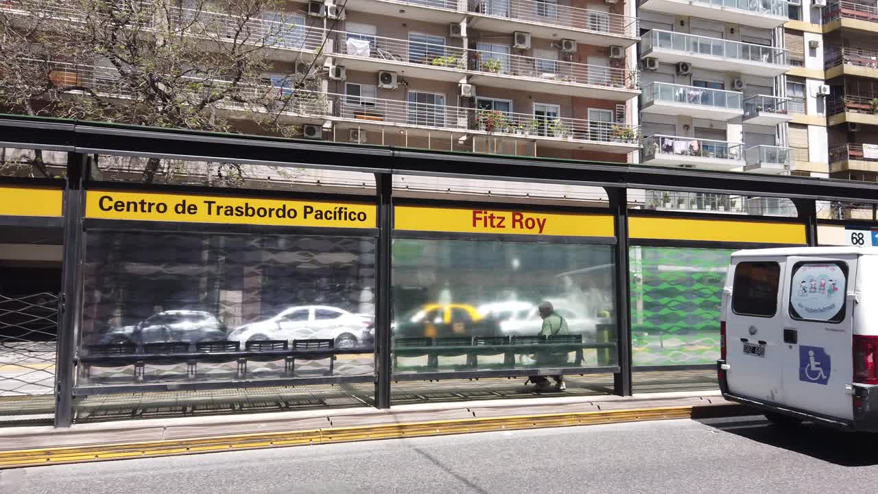 Establishing shot at Fitz Roy station in Palermo neighborhood, traffic of Buenos Aires city in summer daylight