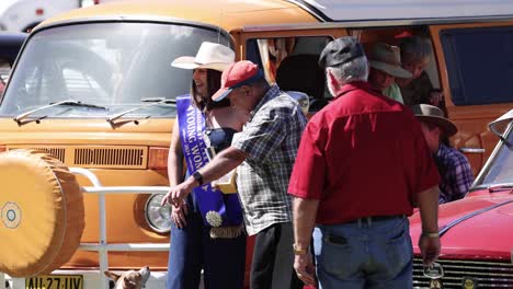 people interacting near classic cars in coonabarabran