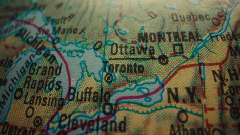 close-up of a vintage world map with canadian cities highlighted