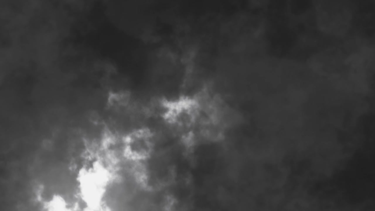 Flying through dark turbulent storm clouds with sudden flash of lightning, dramatic cinematic background for weather or horror concepts