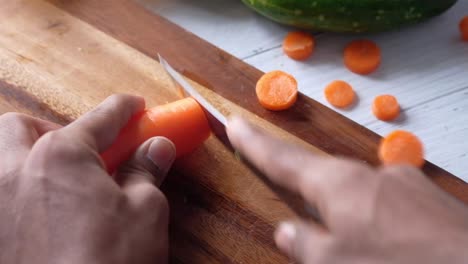 cutting carrots on a wooden cutting board