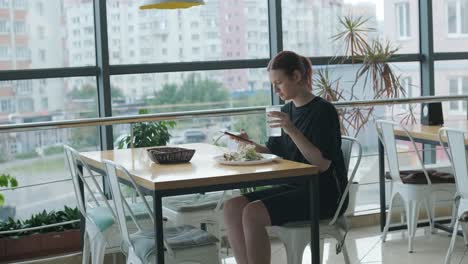 girl eating salad in cafe