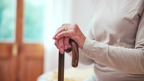 cane, hands and elderly woman in home in bedroom