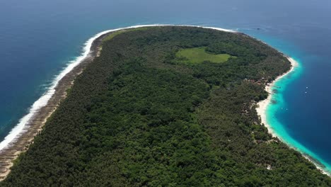 aerial view of jungle and palm tree covered island with beautiful beach in north sumatra, indonesia