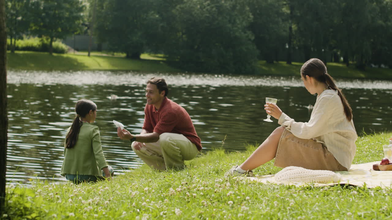 Family enjoying a picnic by the lake