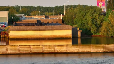 Aerial-reveal,-river-water,-vehicle-movement,-expressway-travel,-nature