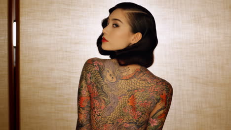 woman with intricate japanese irezumi back tattoo