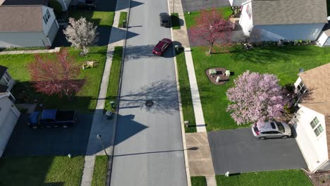 aerial view of a moving vehicle on the road from a residential area in the usa
