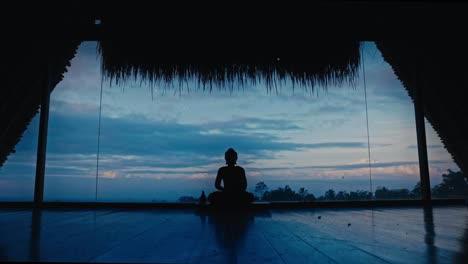 Silhouette-of-praying-buddha-statue-under-fading-light