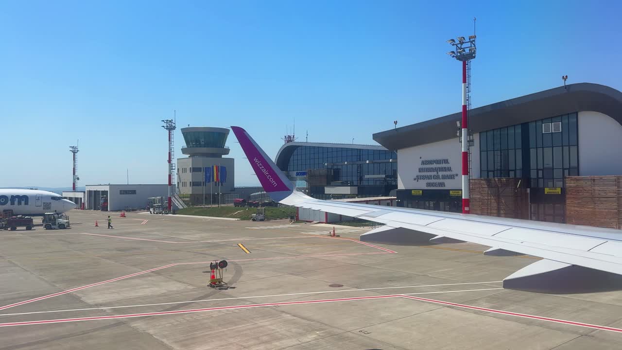 Airplane plane wing Suceava airport tarmac Romania Airbus A320 window view