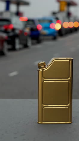 golden fuel can on a road with blurred traffic