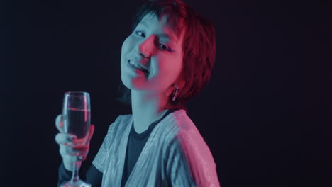 woman celebrating with champagne in neon light