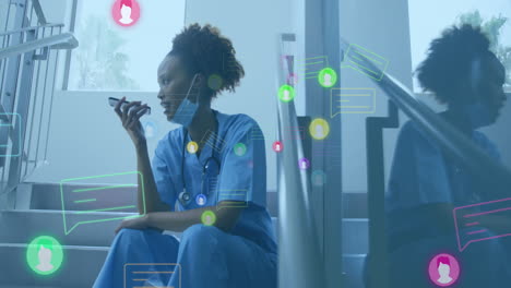 animation of icons and data processing over african american female doctor