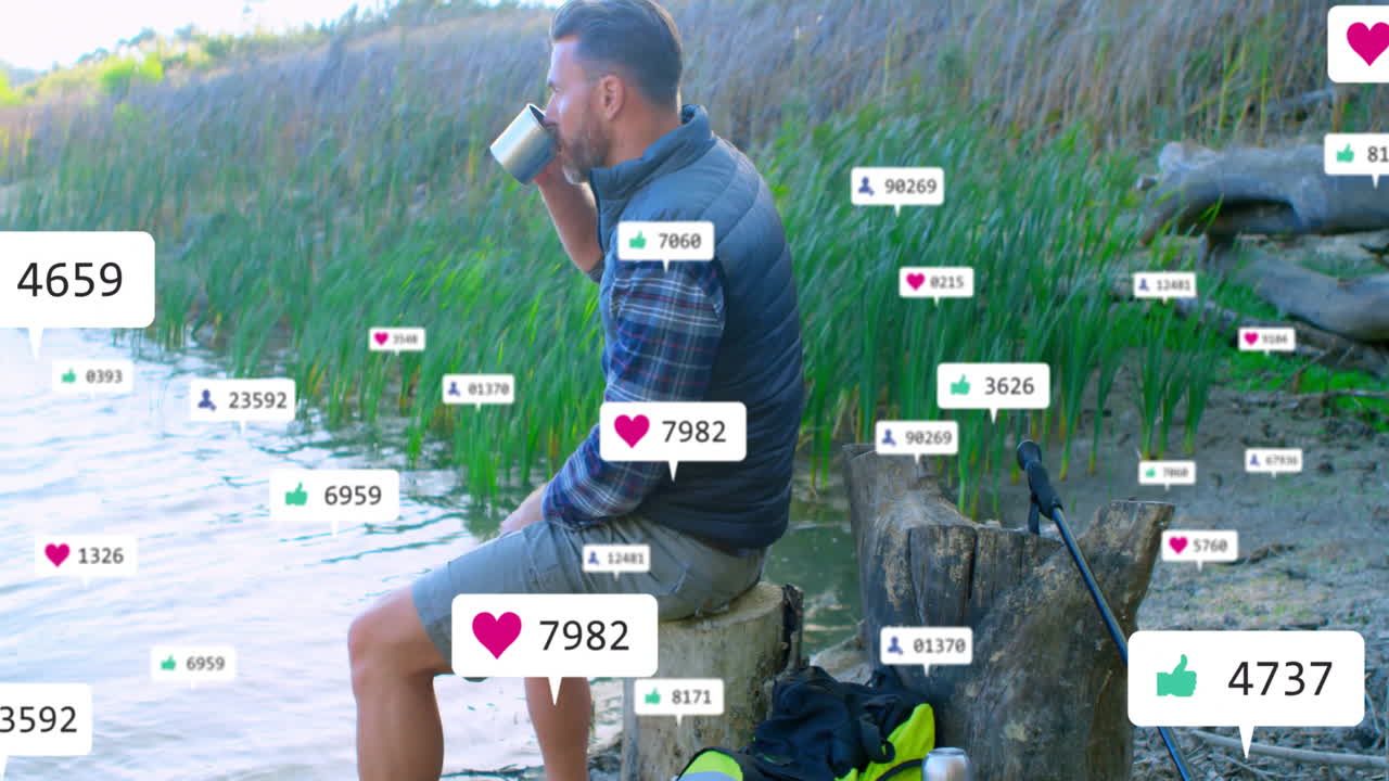 Bearded man sipping from mug on stump lakeside, showing social media analytics icons