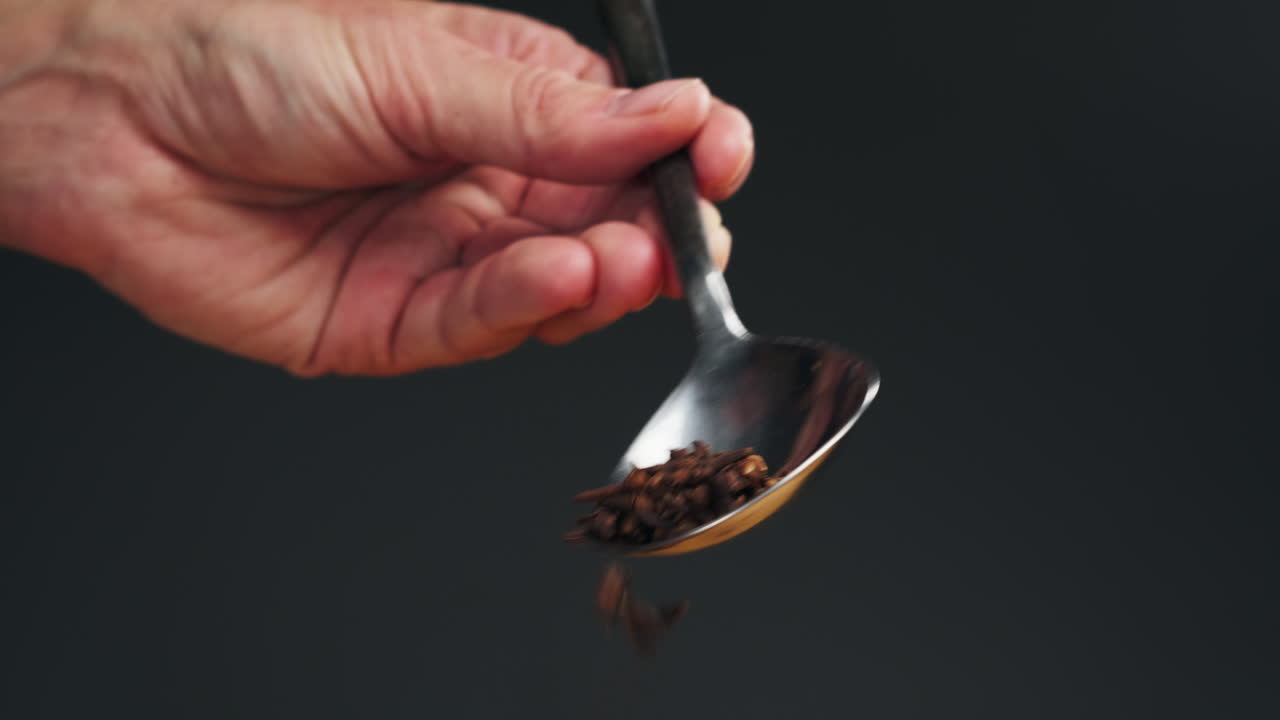 Carnation spice on spoon macro close-up. Collection. Dry spice cloves. Selective focus.Spice for food and drinks. High quality 4k footage