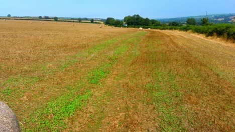 Close-aerial-fly-by-two-golden-bales