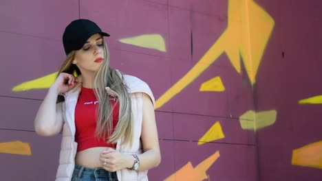 beautiful young blonde woman poses for the camera in trendy, fashionable clothes