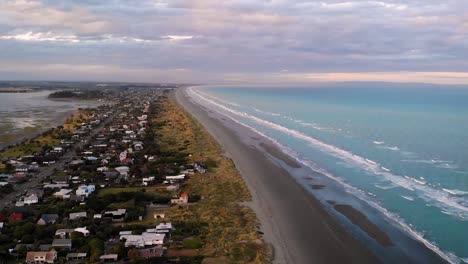 new brighton beach, christchurch, new zealand aerial shot fly forward above shore