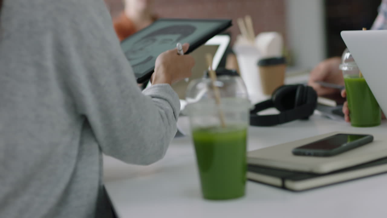 디지털 태블릿 컴퓨터를 사용하여 얼굴 인식 소프트웨어 기술을 개발하는 엔지니어 그룹이 바쁜 사무실 회의에서 프로젝트 아이디어를 공유하는 디자인 솔루션 브레인스토밍