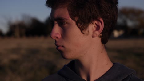 a young teenage boy looks slowly behind him and sees jesus christ - or a man wearing a white robe - standing behind him