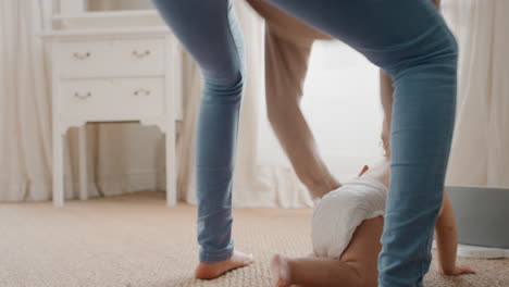 happy baby crawling toddler exploring with curiosity at home with mother gently picking up her infant helping child motherhood responsibility 4k