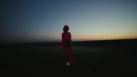woman in a field at sunset