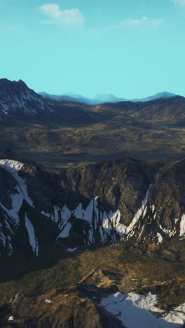 aerial view of a mountain range with snow