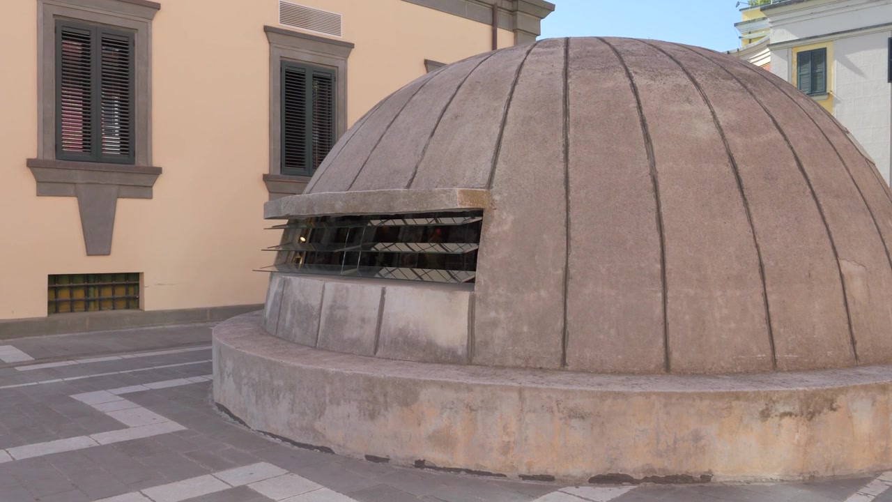 Ingresso del bunker a cupola in cemento del Museo Bunk’Art 2 con finestra a lamelle metalliche accanto all'edificio adiacente a Tirana