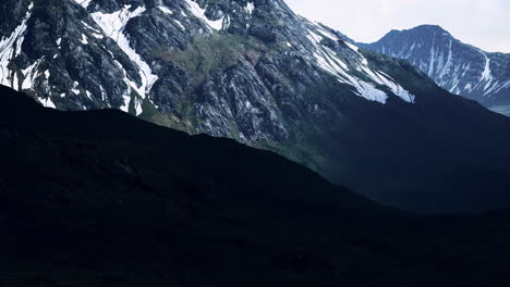 mountain gorge with green meadow illuminated by the sun