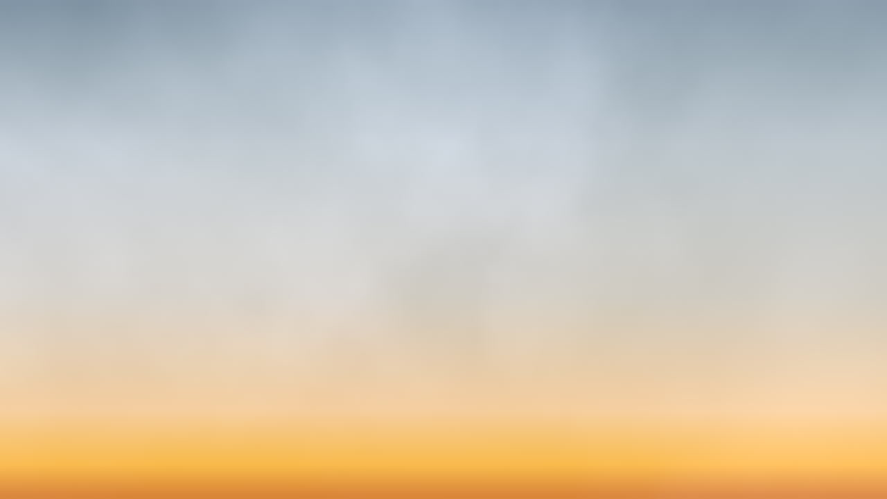 오렌지색, 노란색, 파란색의 혼합물인 흐릿한 구름과 함께 활기찬 일몰 하늘