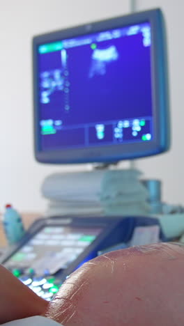 pregnant lady on ultrasound check up. blue screen at the backdrop showing the baby development. vertical video