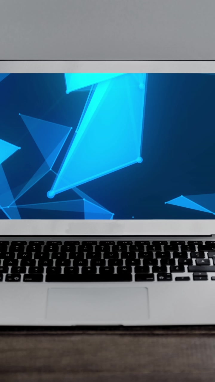 Animation of technological devices with blue shapes on screen on desk
