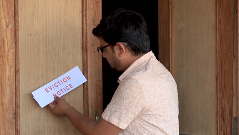 tenant comes out of the house to find eviction notice sticking on the front