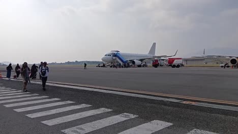 passengers boarding an airplane at the airport