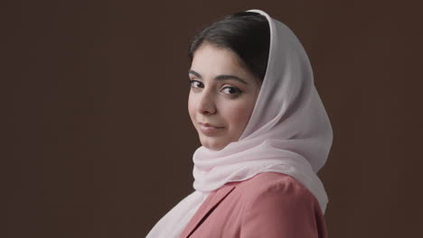 woman in hijab and pink blazer