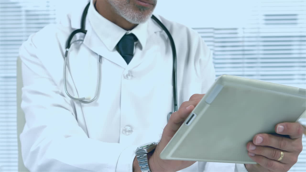 Animation of red pattern over caucasian male doctor using tablet