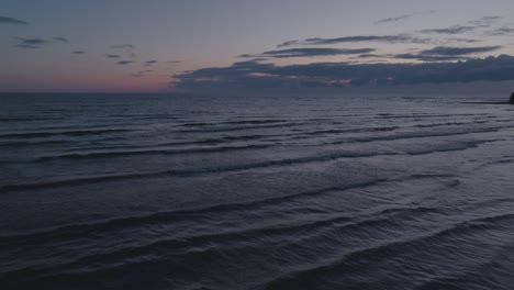 Gentle-waves-at-dusk-on-Owen-Sound,-Ontario,-with-soft-light-reflecting-off-calm-waters,-wide-shot