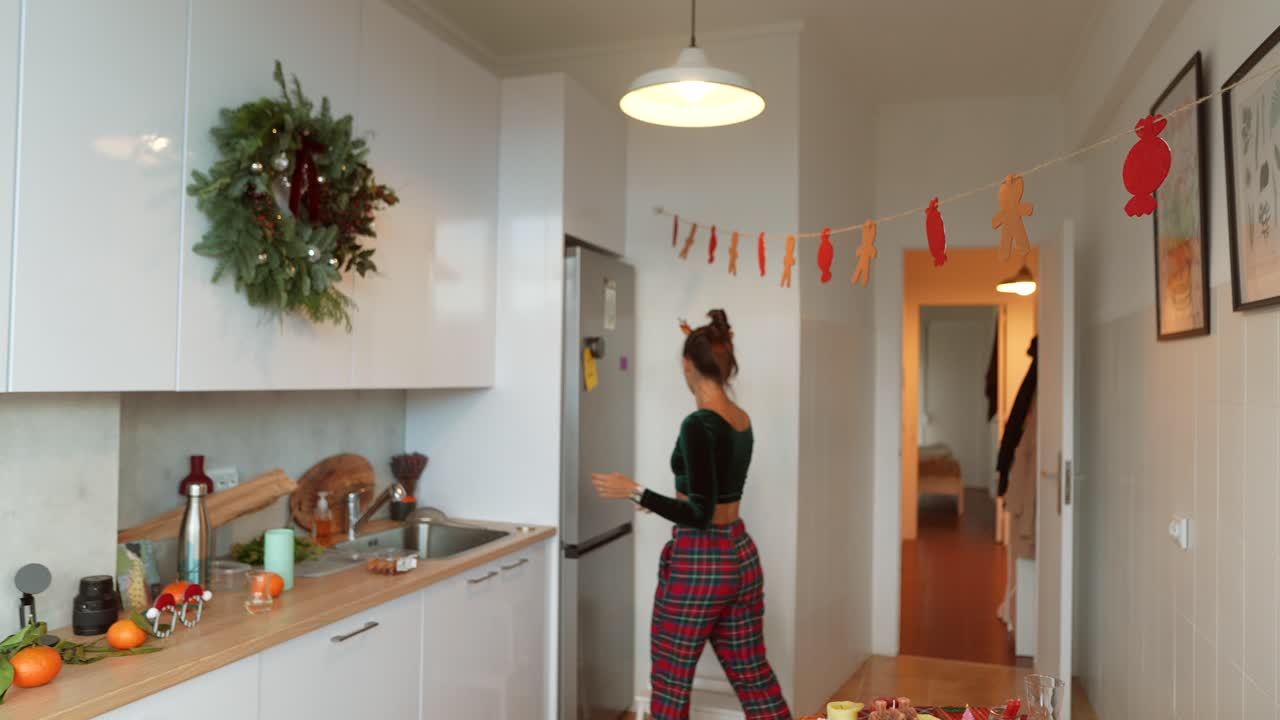 Festive Kitchen Scene with Woman and Holiday Decorations