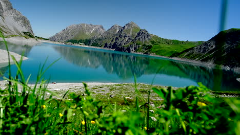 a blue lake surrounded by mountains and alps in austria