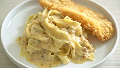 homemade fettuccine pasta white cream sauce with fried fish