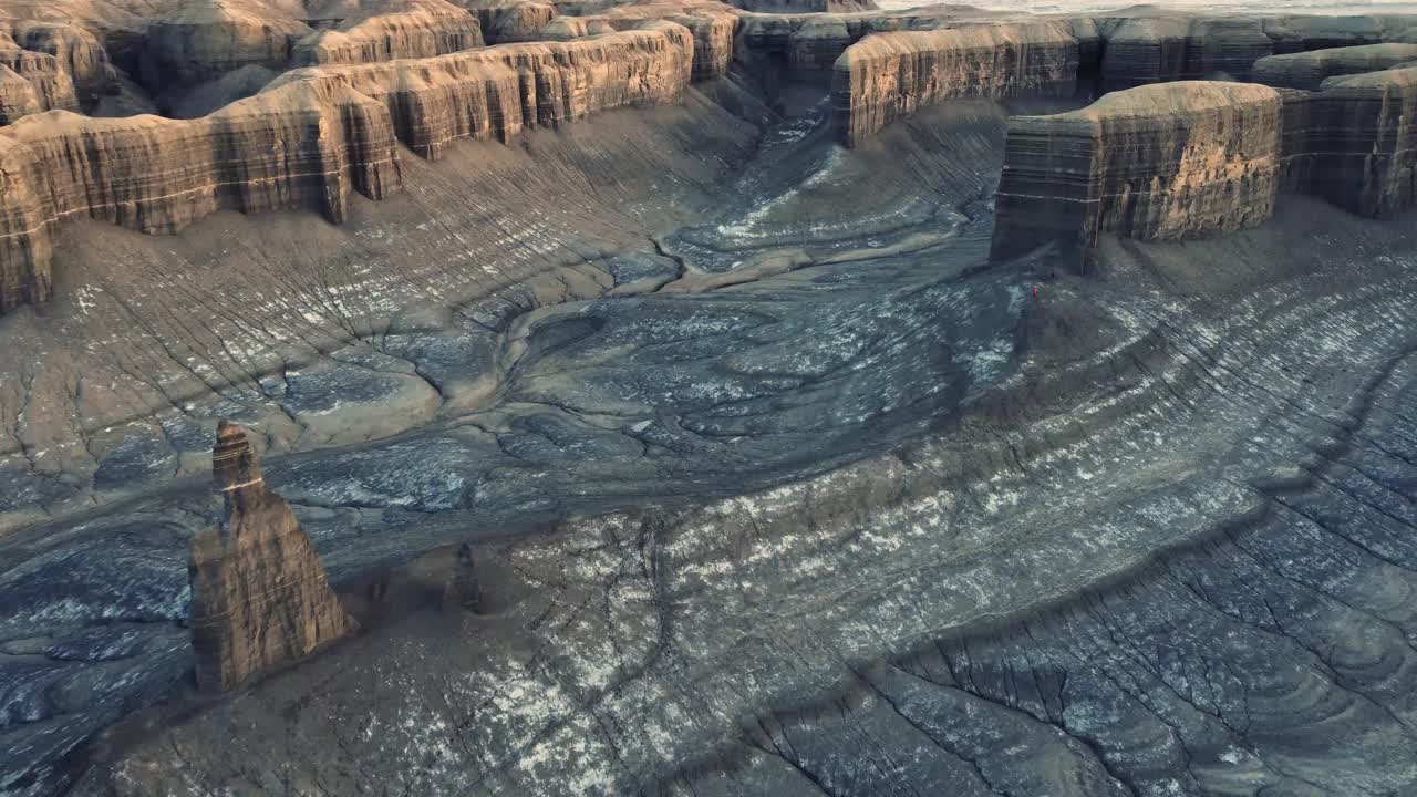 Sharp rock formations in mountainous valley under sunset sky