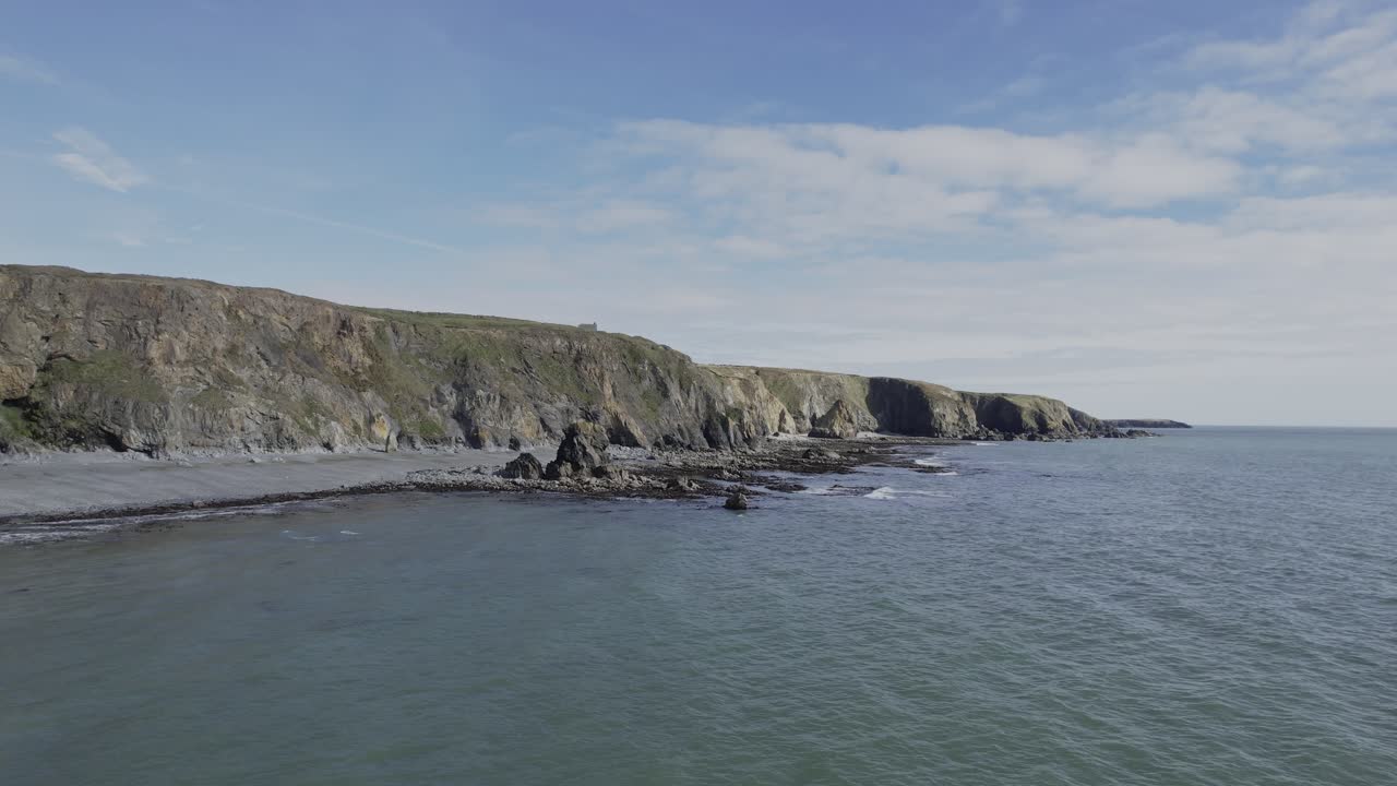 Drone flying over calm seas to rocky coastline Copper Coast Waterford Ireland epic locations and landscapes