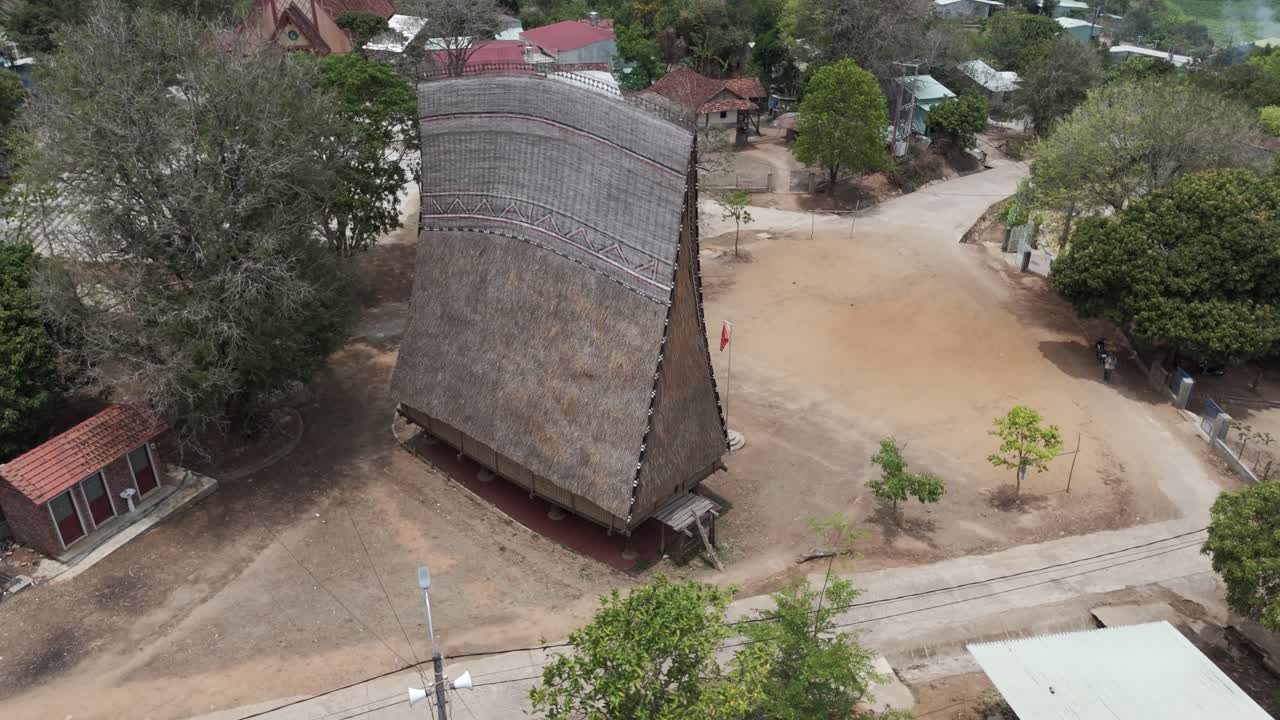 Aerial drone footage along a traditional wooden house from Bahnar minory in central highland Vietnam. Kon Tum province