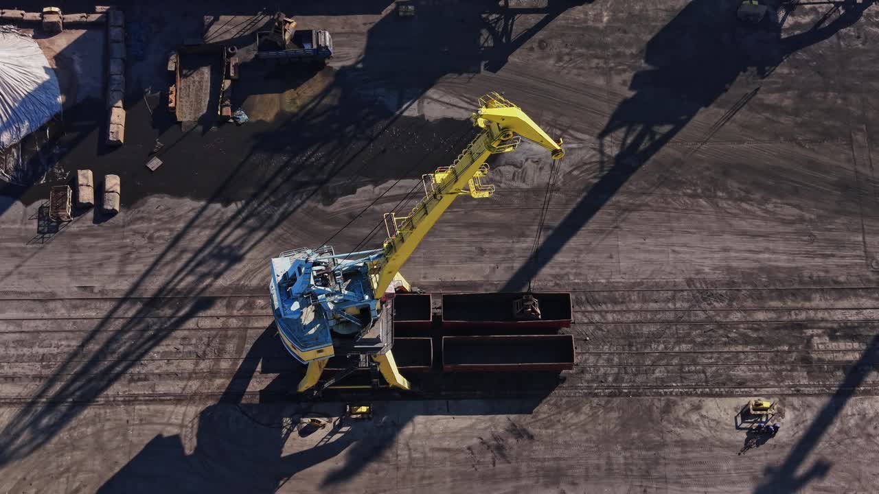Top down view of port crane shadow on industrial ground