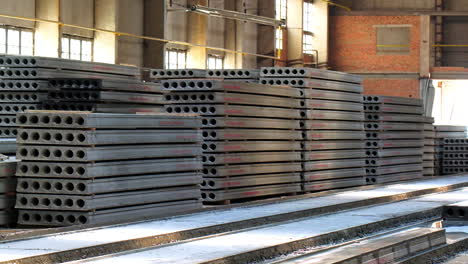 the armored concrete plates with holes inside stacked in piles. ferroconcrete materials inside the construction industrial plant.
