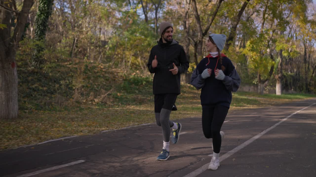 Couple jogging in autumn park