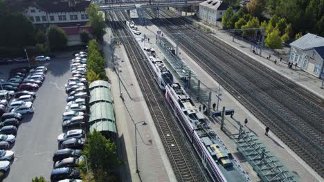 railway station in kerava finland, flock of pigeons flies past twice