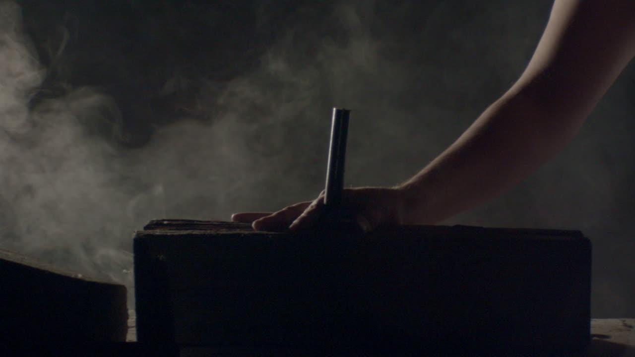 Hammer hitting a big nail in a dramatic misty ambience