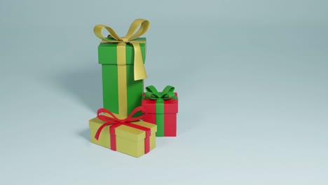 Video-of-three-christmas-presents-spinning-with-copy-space-over-grey-background